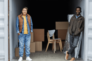 two men standing just inside a storage unit